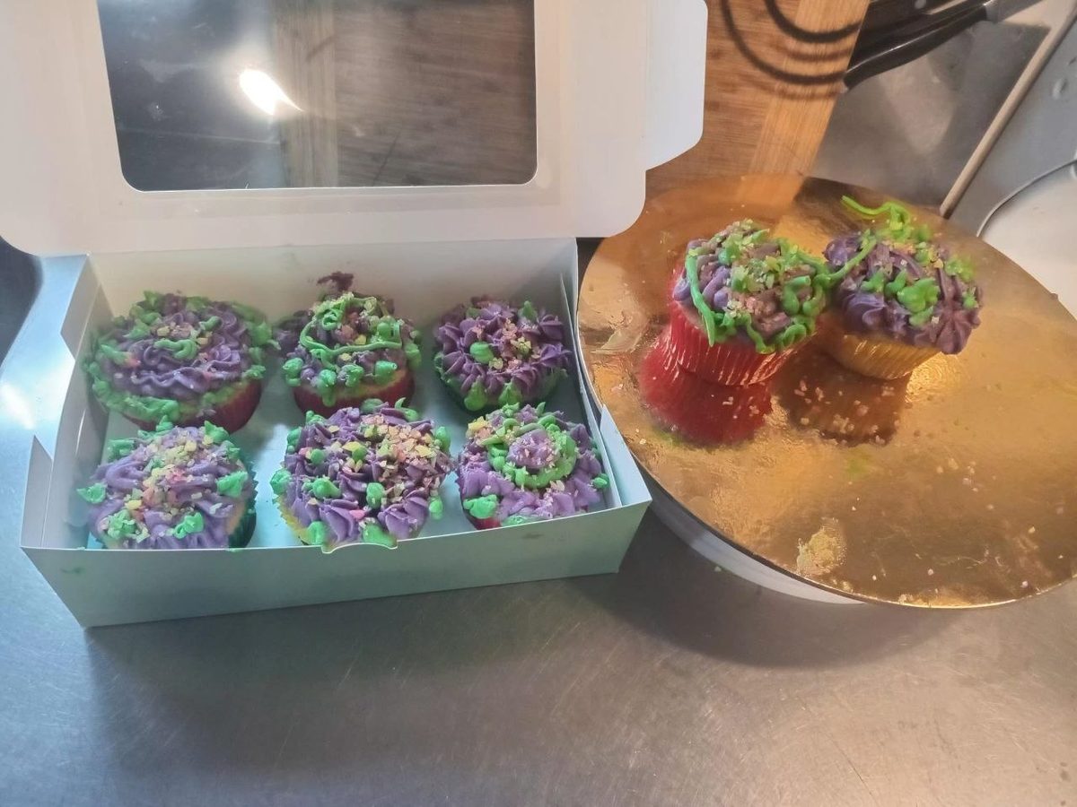 Purple and green cupcakes in gift box