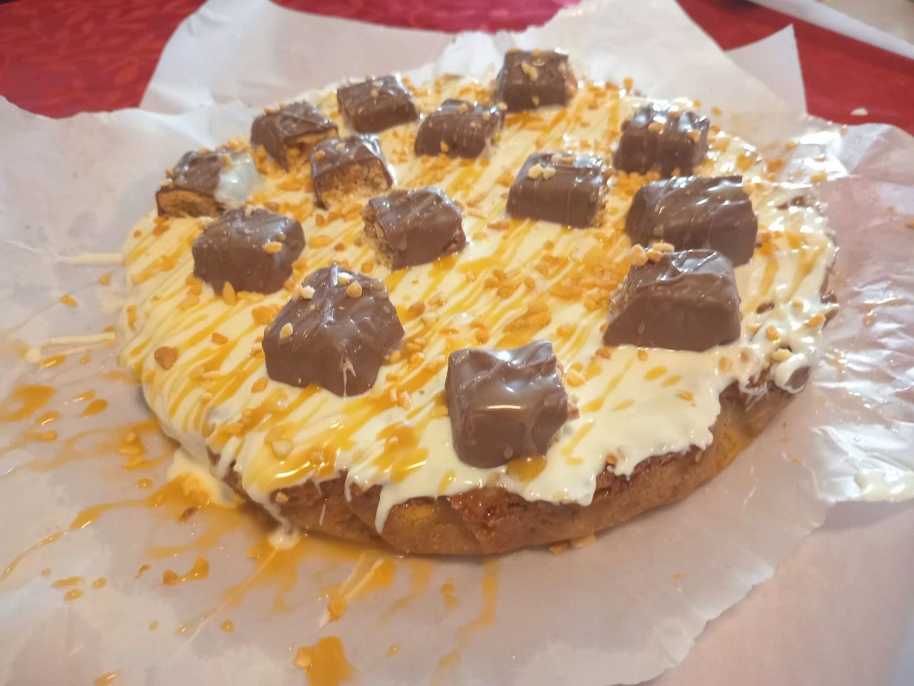 Cookie cake with caramel and cream cheese frosting