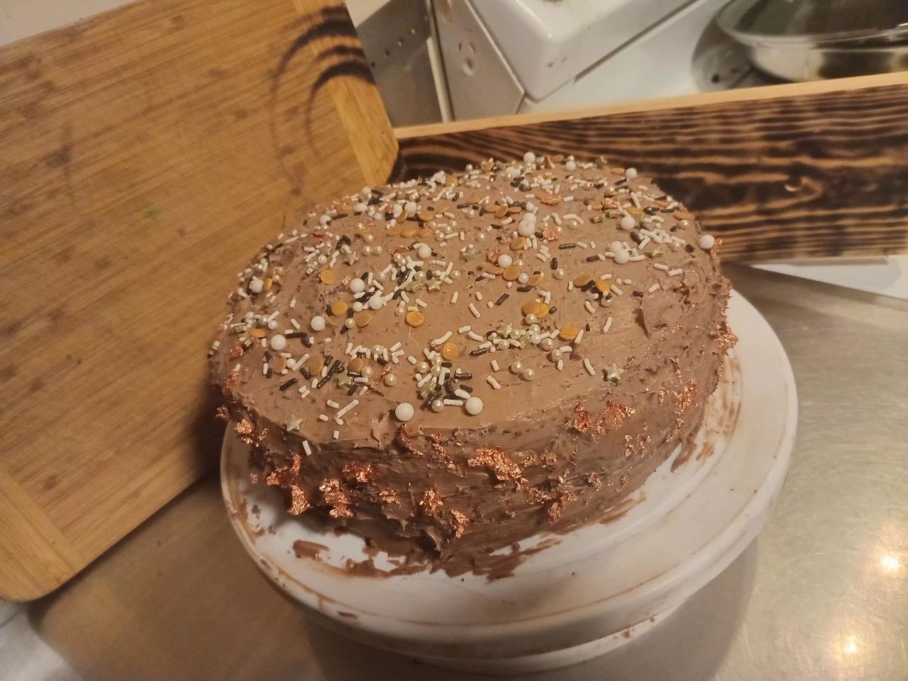 Chocolate cake with copper leaf and sprinkles