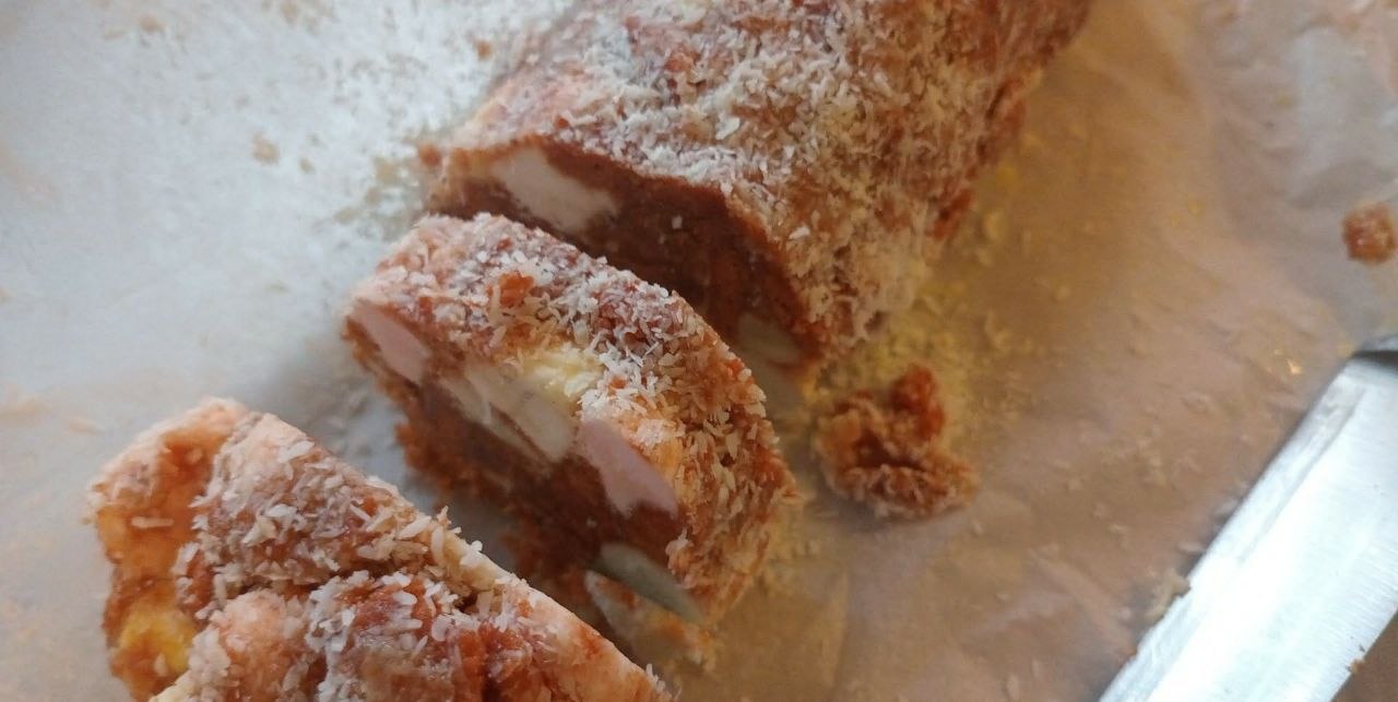 Coconut cream roll, sliced to show filling